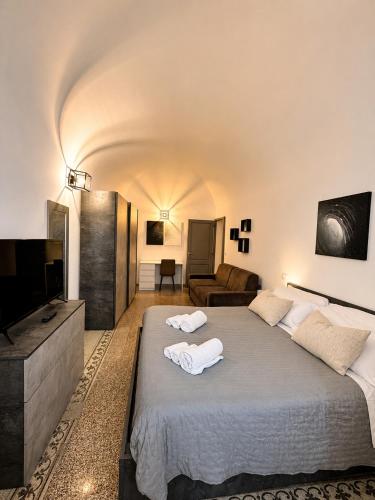 a bedroom with a large bed with towels on it at Giulivi Assisi Apartments in Assisi
