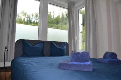a bed with two stuffed animals sitting on top of it at Château d'Harnoy in Yvoir