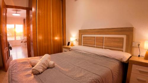 a bedroom with a bed with a stuffed animal on it at Apartalux Cielo Dorado in San Juan de los Terreros