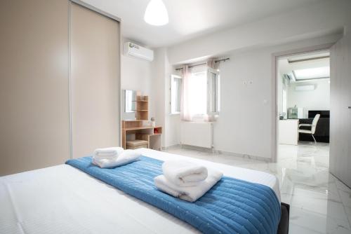 a bedroom with a bed with towels on it at Newly built detached house with parking 2 in Larisa
