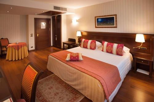 Кровать или кровати в номере Hotel Calissano