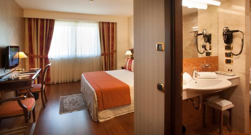 Postel nebo postele na pokoji v ubytování Hotel Calissano