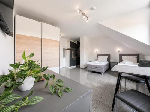 a living room with a couch and a table with plants at Lipp Apartments in Cologne