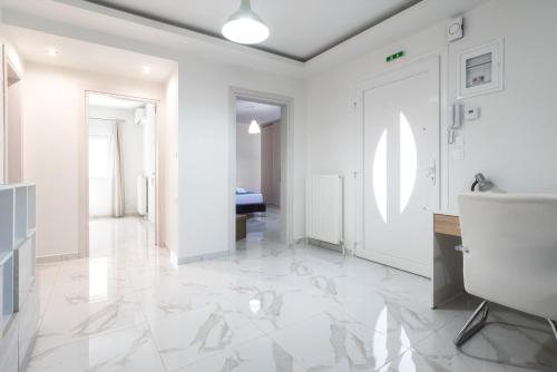 a white hallway with white walls and white floors at Newly built detached house with parking 2 in Larisa