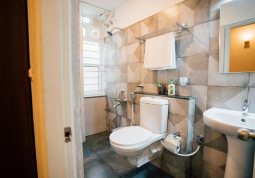 a bathroom with a toilet and a sink at Founder Startup House, Koramangala in Bangalore