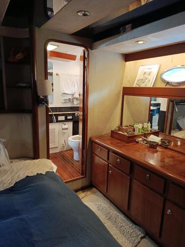 a bedroom with a vanity and a mirror and a bathroom at The boathouse in Benalmádena
