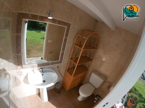 a bathroom with a sink and a mirror and a toilet at Chalets en Sancti Petri in Novo Sancti Petri