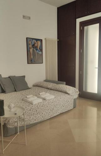 a room with a bed and a table in it at Casa Ferrante in Lecce
