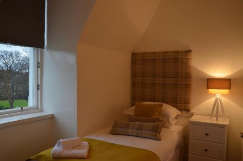 a small bedroom with a bed and a window at Edinburgh37 in Edinburgh