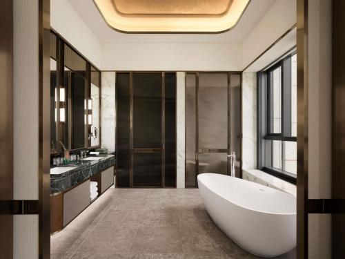 a bathroom with a large tub and a sink at Pullman Ambassador Seoul Eastpole in Seoul