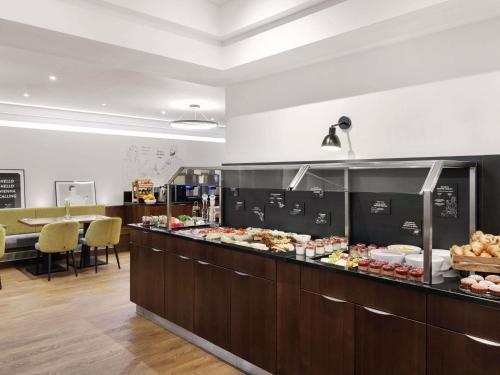 a buffet line with many different types of food at Hotel Rathauspark Wien - Handwritten Collection in Vienna
