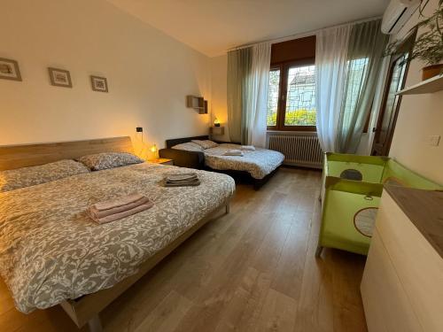 a bedroom with two beds and a window at Residence Ai Melograni in Silea
