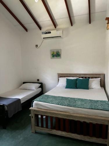 a bedroom with two beds in a room at Shells By D in Negombo