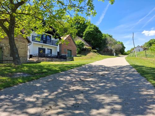 a road in front of a house at Mecsek Vendégház in Mecseknádasd