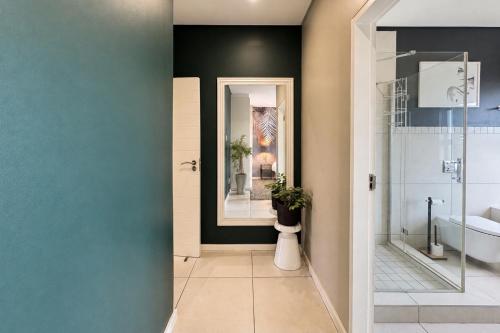 a bathroom with a shower and a toilet and a sink at Ballito Zimbali Wedge in Ballito