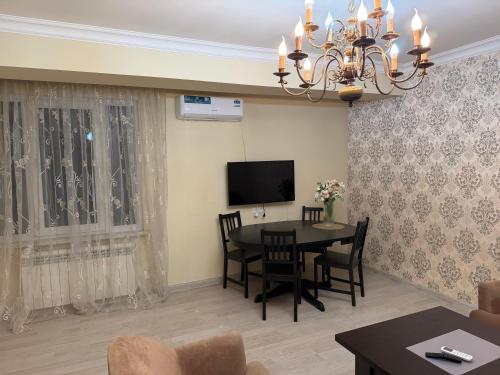 a living room with a table and a television at Erebuni in Yerevan
