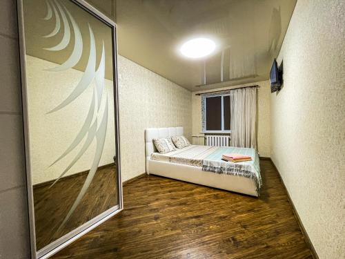 a small room with a bed and a large mirror at Апартаменти ТЦ Галактика in Kremenchuk