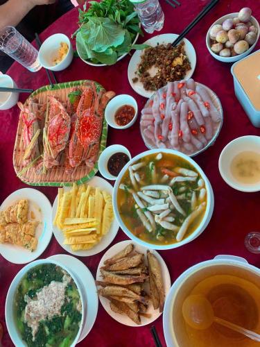 a table topped with plates of food and bowls of soup at Mia's Homestay in Quang Ninh