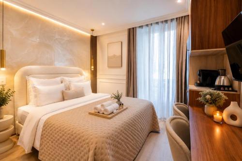 a hotel room with a bed with a tray with stuffed animals on it at Garbo Hôtel in Paris