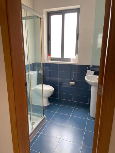 a bathroom with a toilet and a sink at Quiet and Lovely Residence in St. Julianʼs