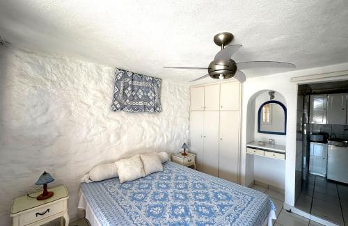 a bedroom with a bed and a ceiling fan at Seafront House, Private Beach, Sunset View, Diliso in Vathírrevma