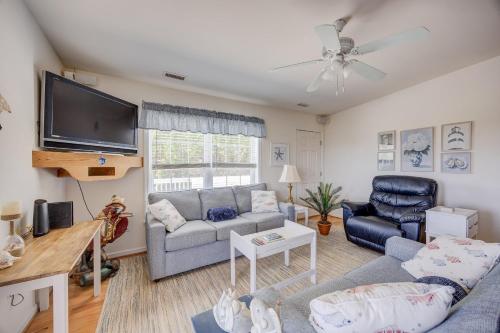 a living room with a couch and a tv at 7630 - Obx Box in Avon