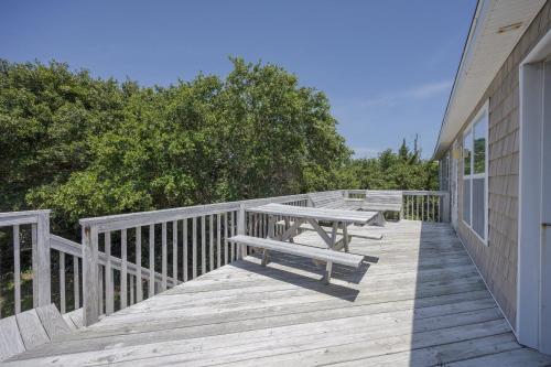 a wooden deck with a picnic table on it at 7630 - Obx Box in Avon