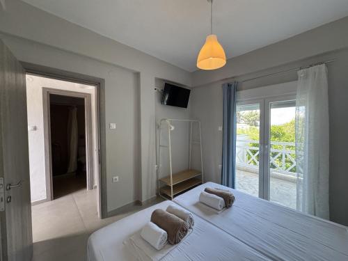 a bedroom with a large bed with a large mirror at Makis House in Nikiti