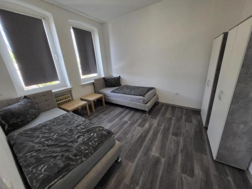 a living room with a bed and a couch at Aparthotel Boardinghouse BRACK mit Parkplatz Küche WIFI in Bielefeld