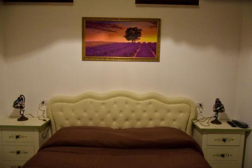 a bedroom with a bed and a picture on the wall at Albadido in Campomarino