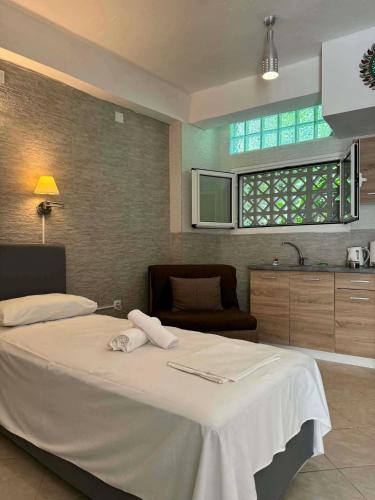 a bedroom with a large bed with towels on it at ABEAS Studios 2 in Avlákia