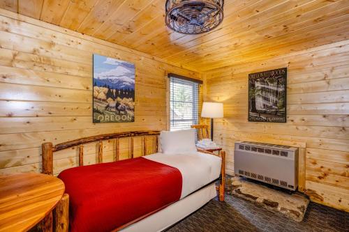 a bedroom with a bed in a log cabin at Union Creek Resort in Union Creek