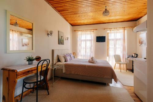 a bedroom with a bed and a table and chairs at Clio apartments in Kambos