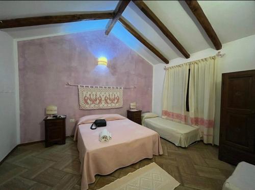 a bedroom with a bed in a room at Agriturismo nuraghe Putzu Canu in Perfugas