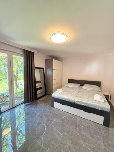 a bedroom with a bed and a large window at Ferienwohnung Otterberg in Otterberg