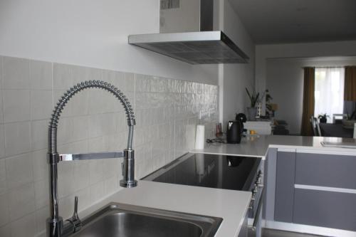 a kitchen with a sink and a faucet at Casa do Tempo in Achada