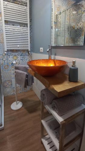 a bathroom with a wooden bowl sink with a mirror at Il Falcineto in Pesaro