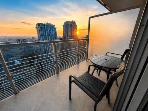 a balcony with a table and a chair on a balcony at Altitude Suites on Yonge - Downtown Toronto Short Walk to SickKids, TMU & Eaton Centre in Toronto