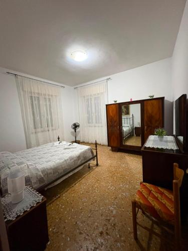 a bedroom with a large bed and a mirror at Casa Rosa Anna in Martinsicuro