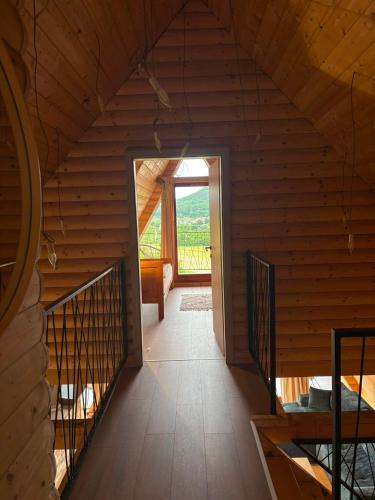 an attic room with a staircase in a wooden house at Kuća za odmor - Villa Magdalena in Otočac