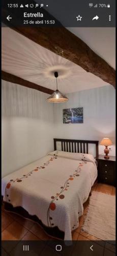 a bedroom with a bed with a blanket on it at Casa Mariana in Lubián