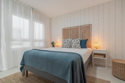 a bedroom with a large bed with blue pillows at Sunny Guargacho4 Retreat-South Tenerife in Guargacho