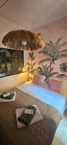 a hotel room with two beds with towels on them at Lola's Sanremo Centro in Sanremo