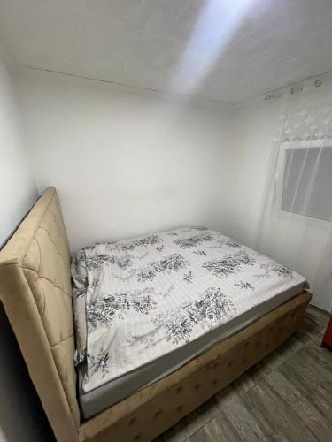 a bed sitting in a corner of a room at Apartman Jovanovic in Sutomore