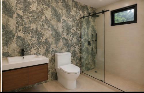 a bathroom with a toilet and a sink and a shower at Monteverde House in Monteverde Costa Rica
