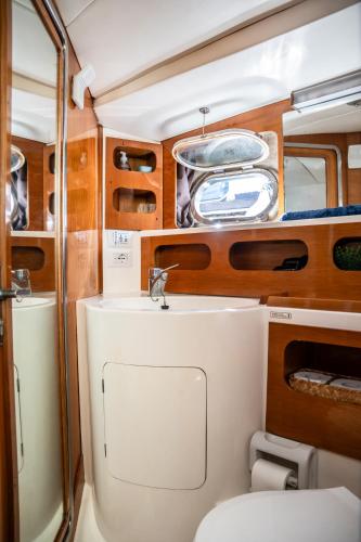 a bathroom with a toilet and a sink at BALI house boat in SantʼAntìoco