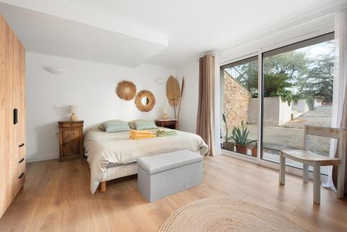a bedroom with a bed and a large window at Villa Marius in Albi