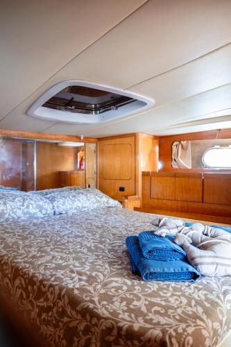 a bedroom with a bed on a boat at BALI house boat in SantʼAntìoco