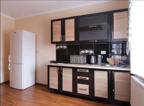 a kitchen with a white refrigerator in a room at Форесок in Vorokhta