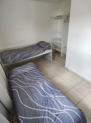 a bedroom with a bed and a cabinet in it at Depto Civora 1 in Villa Regina